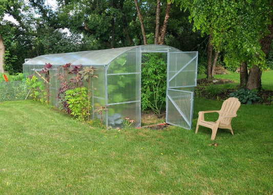 Heavy-duty greenhouse kit with galvanized steel frame and polycarbonate twin walls, designed to withstand harsh weather conditions.