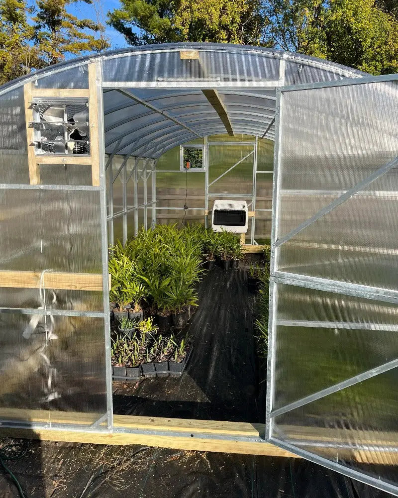 Heavy-duty greenhouse kit with galvanized steel frame and polycarbonate twin walls, designed to withstand harsh weather conditions.