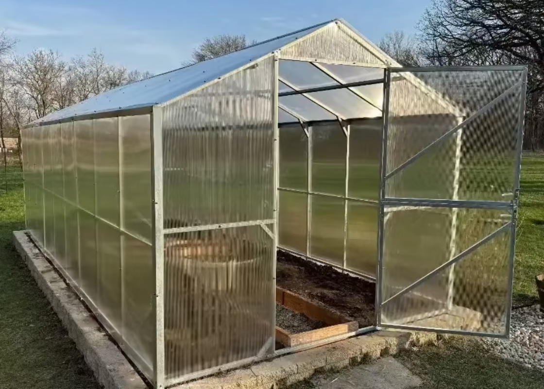 Heavy-duty greenhouse kit with galvanized steel frame and polycarbonate twin walls, designed to withstand harsh weather conditions.