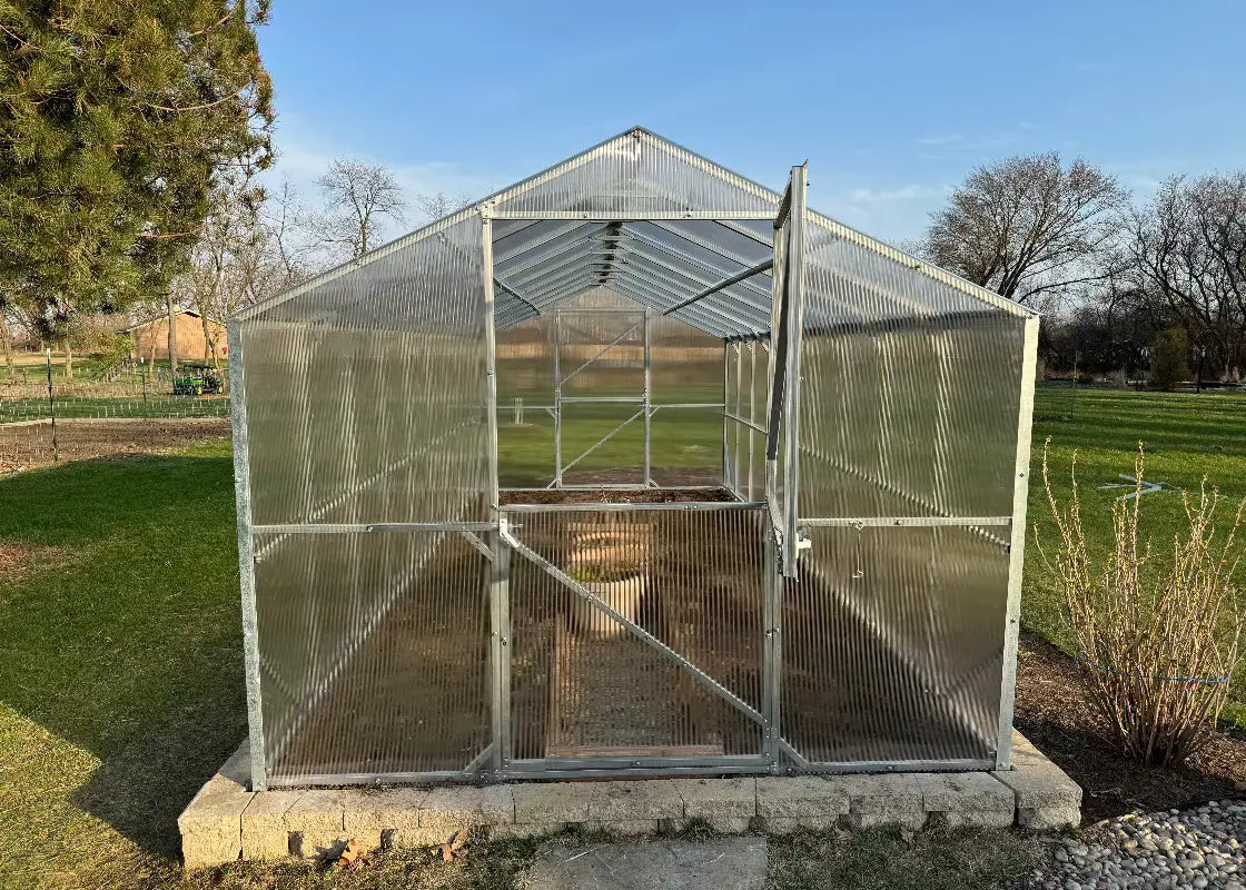 Heavy-duty greenhouse kit with galvanized steel frame and polycarbonate twin walls, designed to withstand harsh weather conditions.