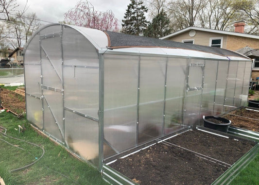 Heavy-duty greenhouse kit with galvanized steel frame and polycarbonate twin walls, designed to withstand harsh weather conditions.