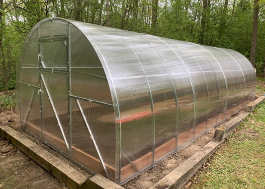 Heavy-duty greenhouse kit with galvanized steel frame and polycarbonate twin walls, designed to withstand harsh weather conditions.