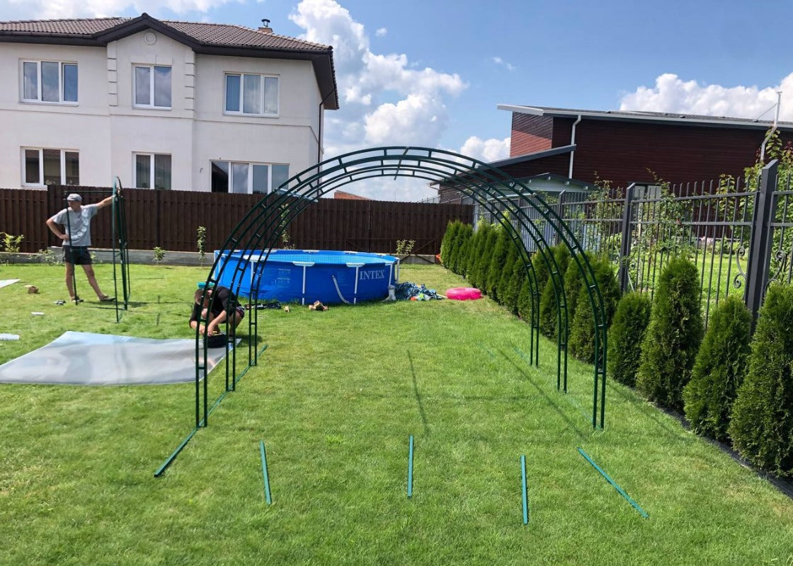 Heavy-duty greenhouse kit with galvanized steel frame and polycarbonate twin walls, designed to withstand harsh weather conditions.