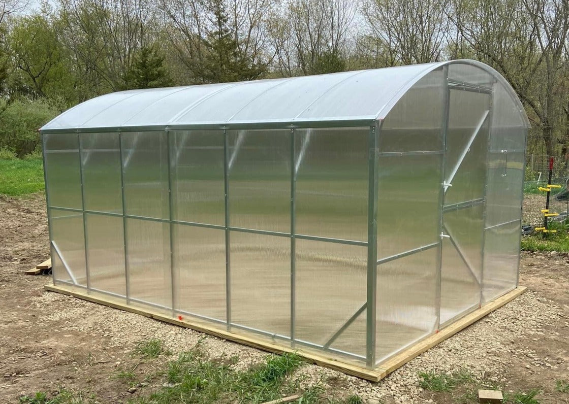 Heavy-duty greenhouse kit with galvanized steel frame and polycarbonate twin walls, designed to withstand harsh weather conditions.