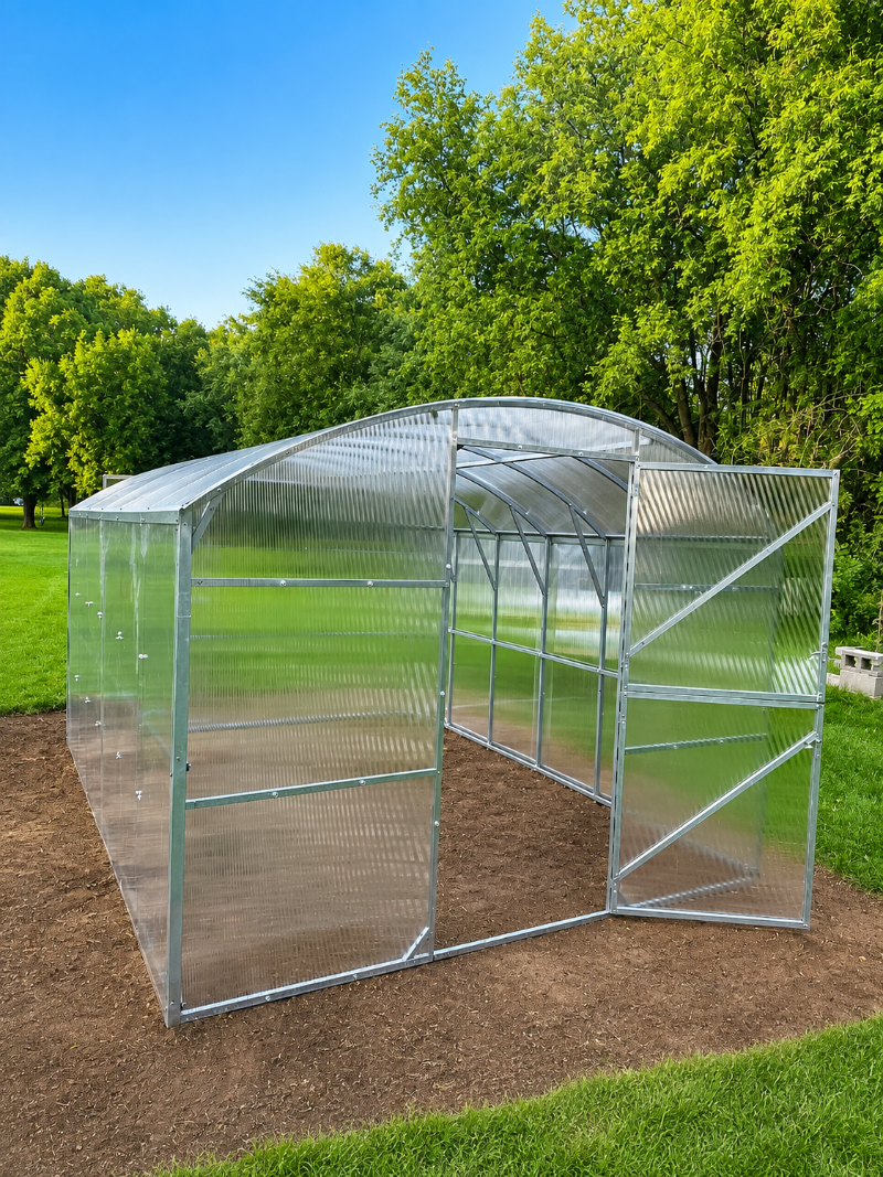 Magnolia reinforced polycarbonate greenhouse with galvanized steel frame and open front door in a backyard garden